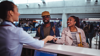 Couple checking in at airport