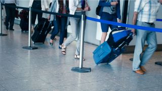 Travelers in line with suitcases