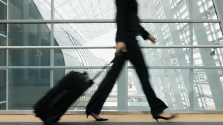 media woman-walking-airport.png