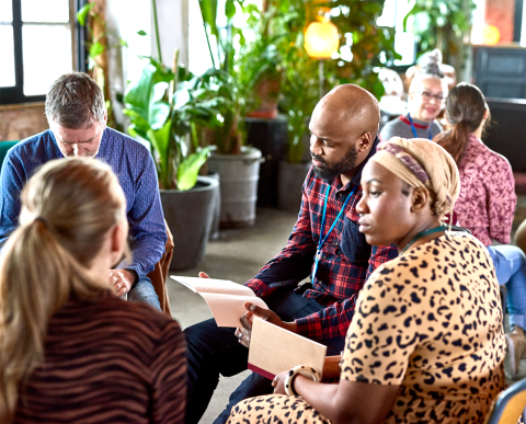 Group of people meeting with note books