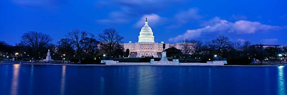 Capitol at night with blue sky and clouds