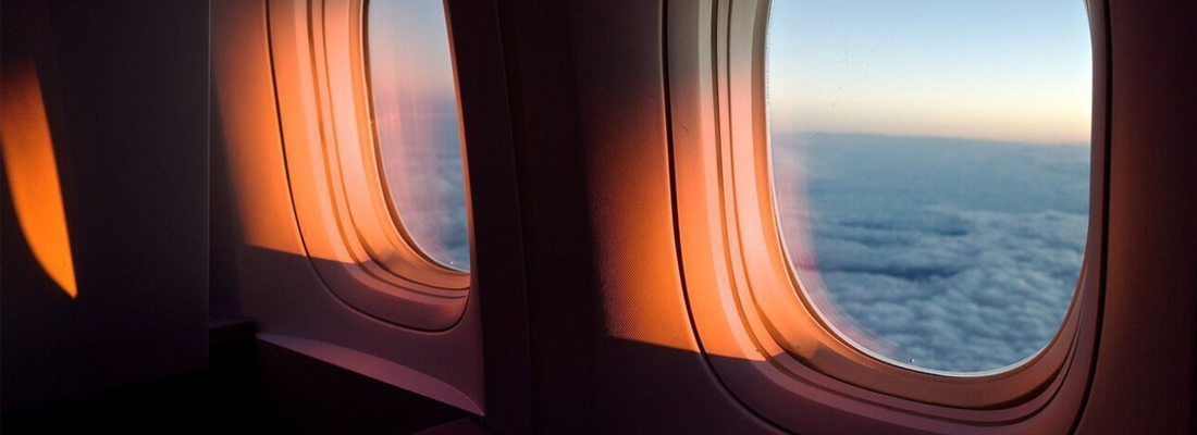 Airplane window at sunset