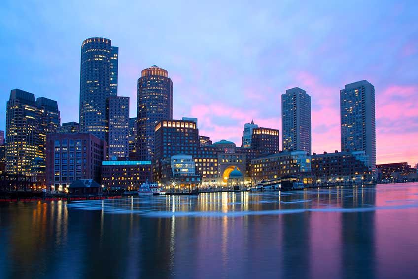 Evening image of Boston Harbor with pink sunset