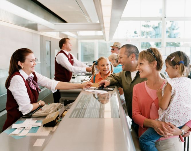 happy family checking into airport 